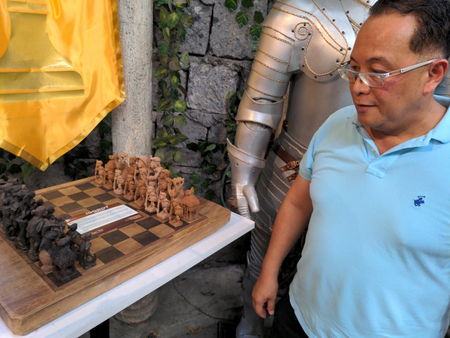 The Igorot chess set, exhibited in the Torre Museum and its proud owner, Dionisio Jundio Salvador