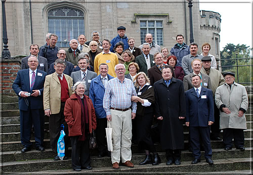 Participants and hosts on the steps leading up to the castle
